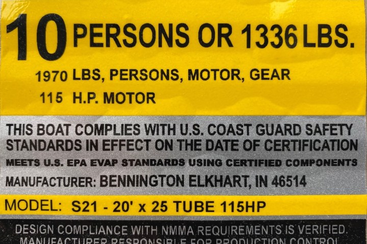 Boat capacity label for 10 persons or 1336 lbs, 115 HP motor, compliance with Coast Guard standards.